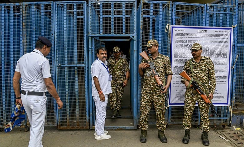 Election security personnel standing outside polling station in Bengal.