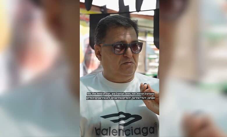 Man wearing sunglasses and a Balenciaga t-shirt, speaking about Iranian Jews in Shiraz.
