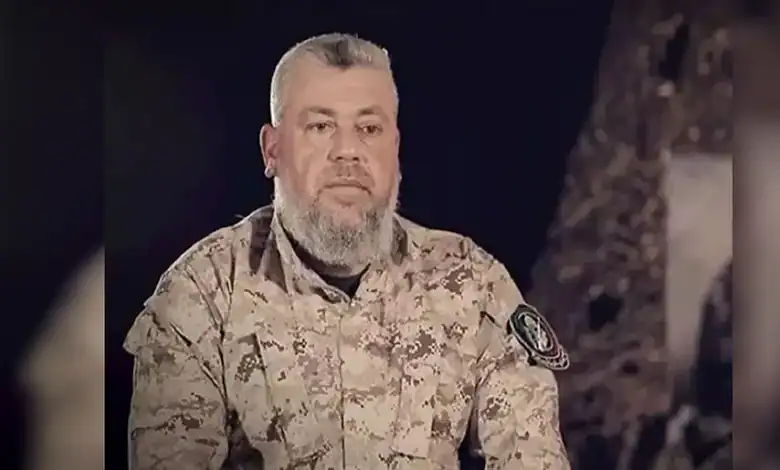 Hamas commander Izz al-Din al-Haddad wearing military uniform during a recorded appearance.