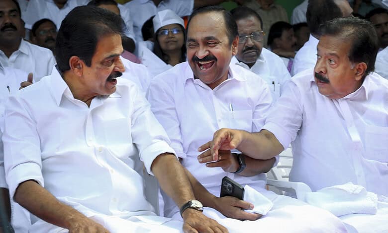 Congress leaders smiling and engaging at a political meeting in Kerala.