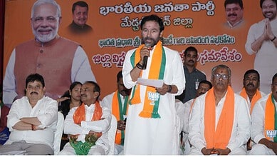 Prime Minister Narendra Modi speaking at a political rally with supporters and leaders, highlighting the.