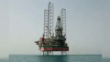 Oil rig platform in the sea with clear sky, offshore drilling, energy industry, and maritime infrastructu.