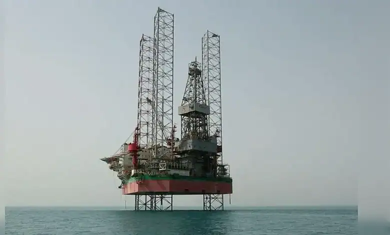 Oil rig platform in the sea with clear sky, offshore drilling, energy industry, and maritime infrastructu.