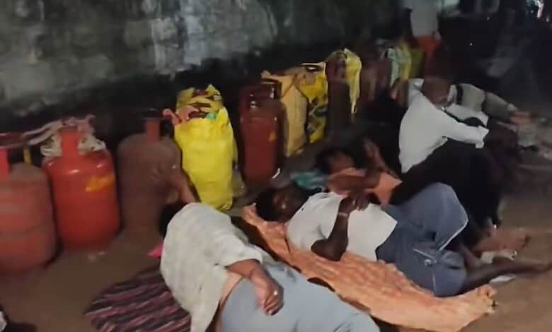Villagers sleep on the street outside a gas agency in Mahabubabad due to gas supply issues despite bookin.