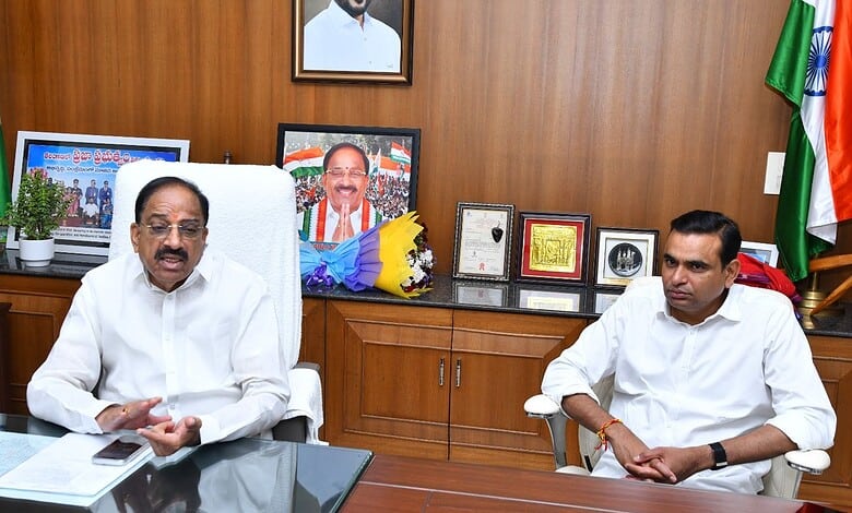 Prominent Indian politician speaking in a formal office setting with flags and framed photographs in the.