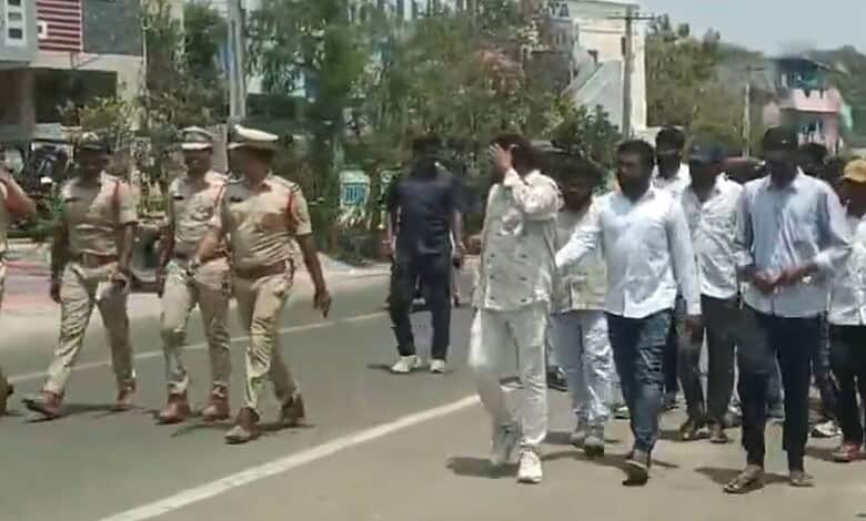 Protesters walking on the street with police officers present, demonstrating public unrest and law enforc.