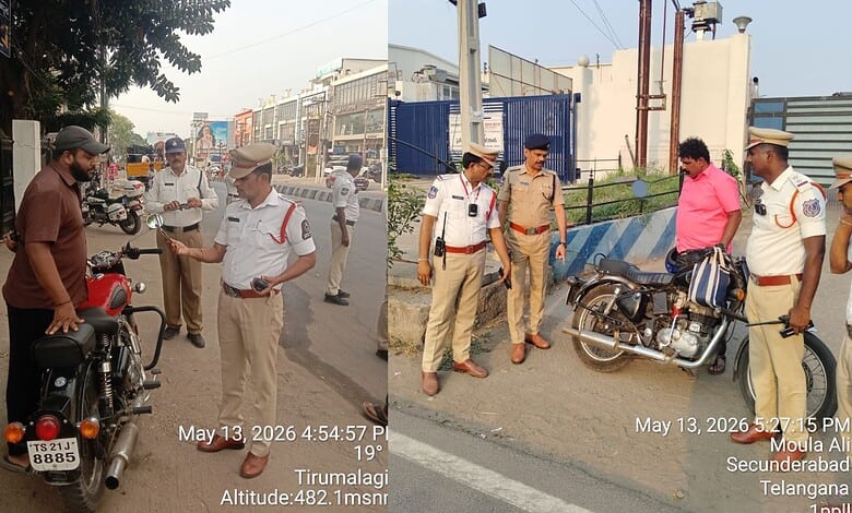 Motorcycle police officers interacting with civilians on a busy street in Tirumalagiri, Hyderabad, India.