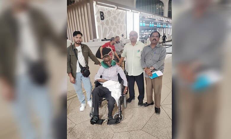 Indian man in wheelchair with family at airport, returning home after stroke treatment in Saudi Arabia.