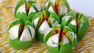 Colourful Modishree and Joy Bangla sweets with silver foil, symbolising Bengal’s festive celebration.