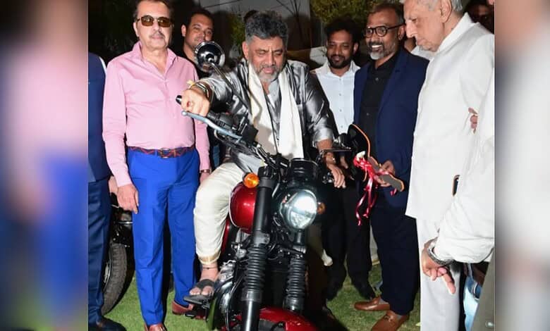 Motorcycle unveiling event with dignitaries and media presence.