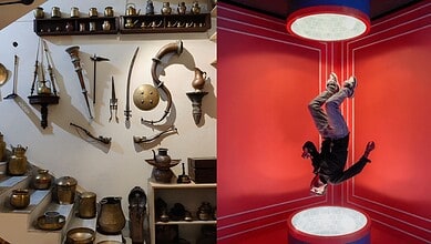 Ancient weapons and artifacts displayed on a museum wall, with a person performing a handstand in a moder.