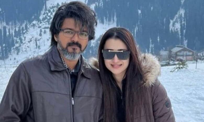 Vijay and Trisha in snowy landscape, celebrating political milestone and personal love.